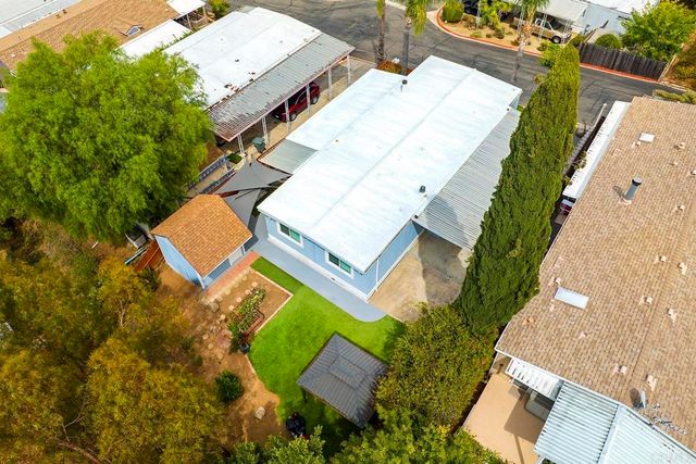 an aerial view of a house with a garden and trees
