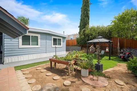 an aerial view of residential houses with outdoor space and river