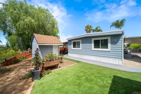 a view of a street with potted plants
