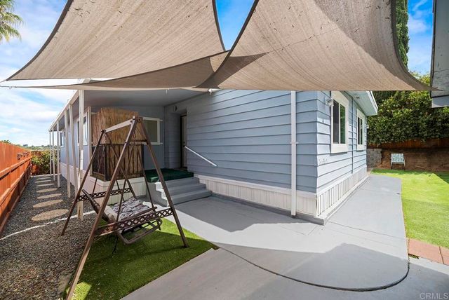 a view of house with a yard