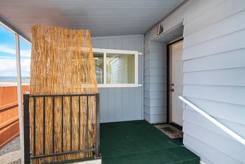 a view of a room with wooden floors