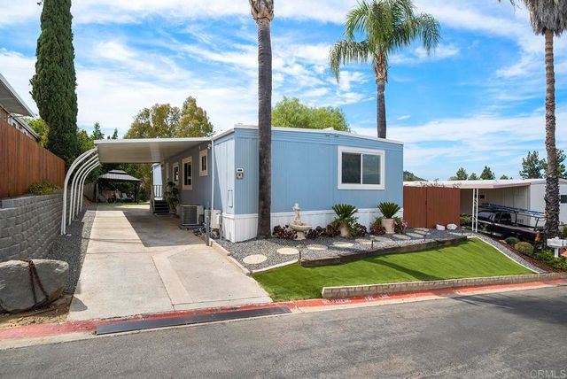 a view of backyard of house with seating space