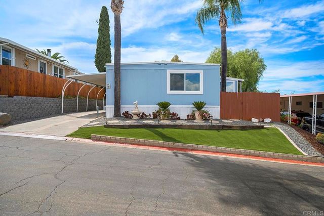 a view of backyard and a car parked