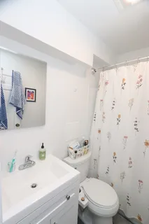 a white toilet sitting next to a bathroom sink