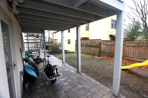 a view of a porch with furniture and a backyard