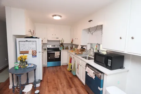 a kitchen with stainless steel appliances a stove a sink and a refrigerator