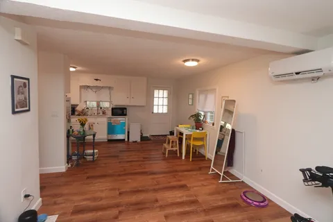 a view of a room with furniture and wooden floor