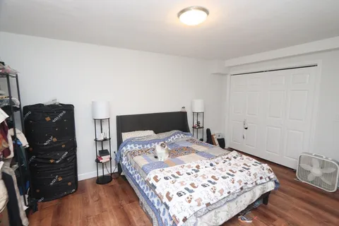 a bedroom with a bed window and dresser