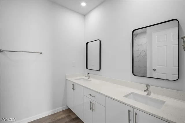 a bathroom with 2 sink and a mirror