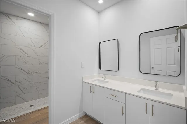 a bathroom with double vanity sink and a mirror