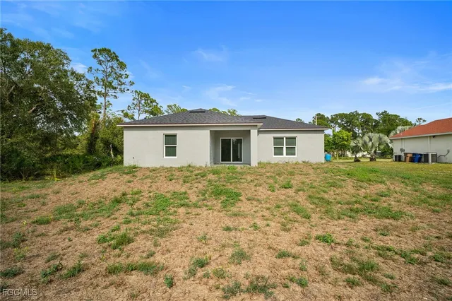 a view of a house with a backyard