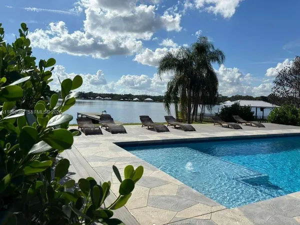 a view of swimming pool with outdoor seating