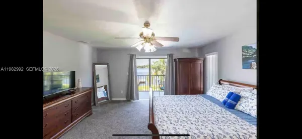 a bedroom with chandelier and flat screen tv