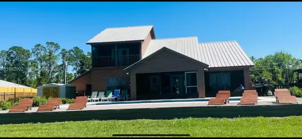 a front view of a house with a yard table and chairs