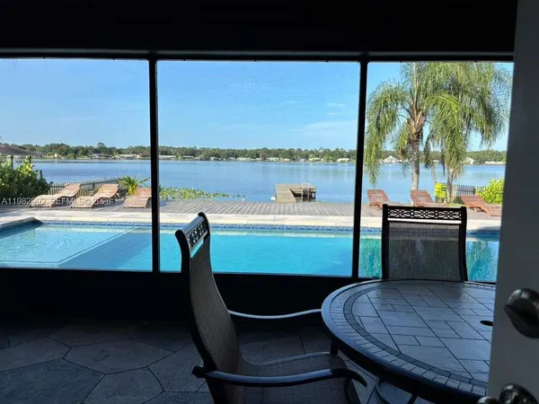 a view of a chairs and table in the balcony