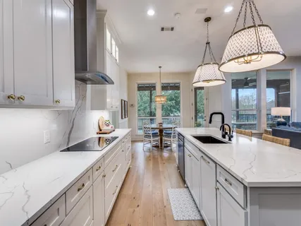 a kitchen with sink stove and cabinets