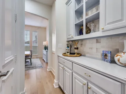 a kitchen with a cabinets and wooden floor
