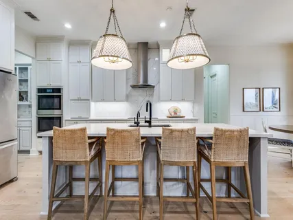 a kitchen with cabinets and chairs