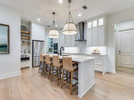 a kitchen with center island cabinets and wooden floor