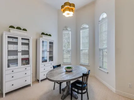 a view of a dining room with furniture and chandelier