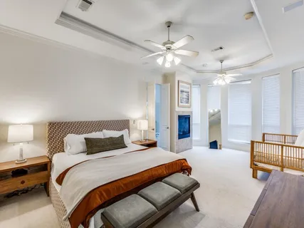 a bedroom with a large bed and a chandelier