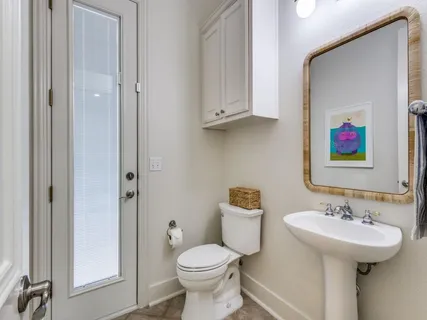 a bathroom with a toilet sink and mirror
