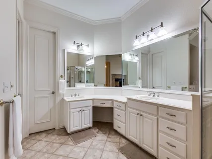 a spacious bathroom with a granite countertop sink mirror and cabinets