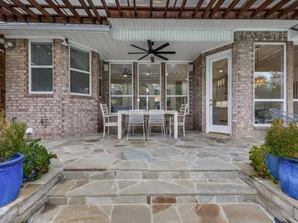 a glass door and chair in front of a house