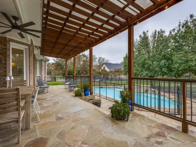 a view of a porch with furniture and backyard