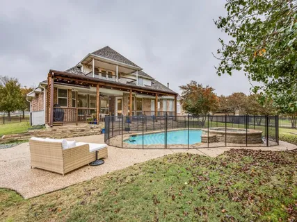 a view of house with a big yard and potted plants