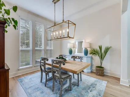 a dining room with furniture a potted plant and a table