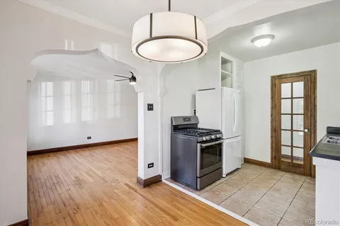 a kitchen with granite countertop a stove and a refrigerator