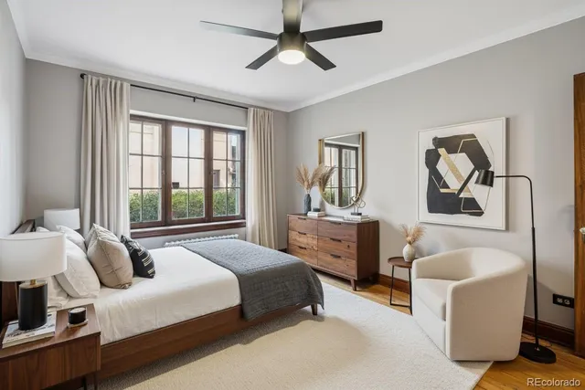 a bedroom with a bed couch and window