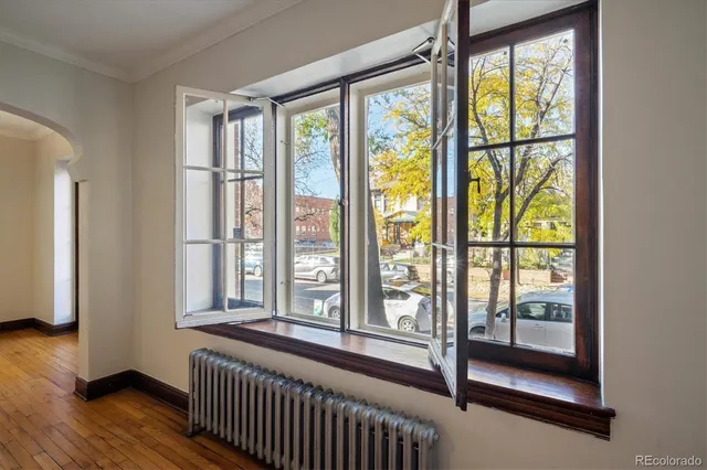 a view of a room with wooden floor and windows