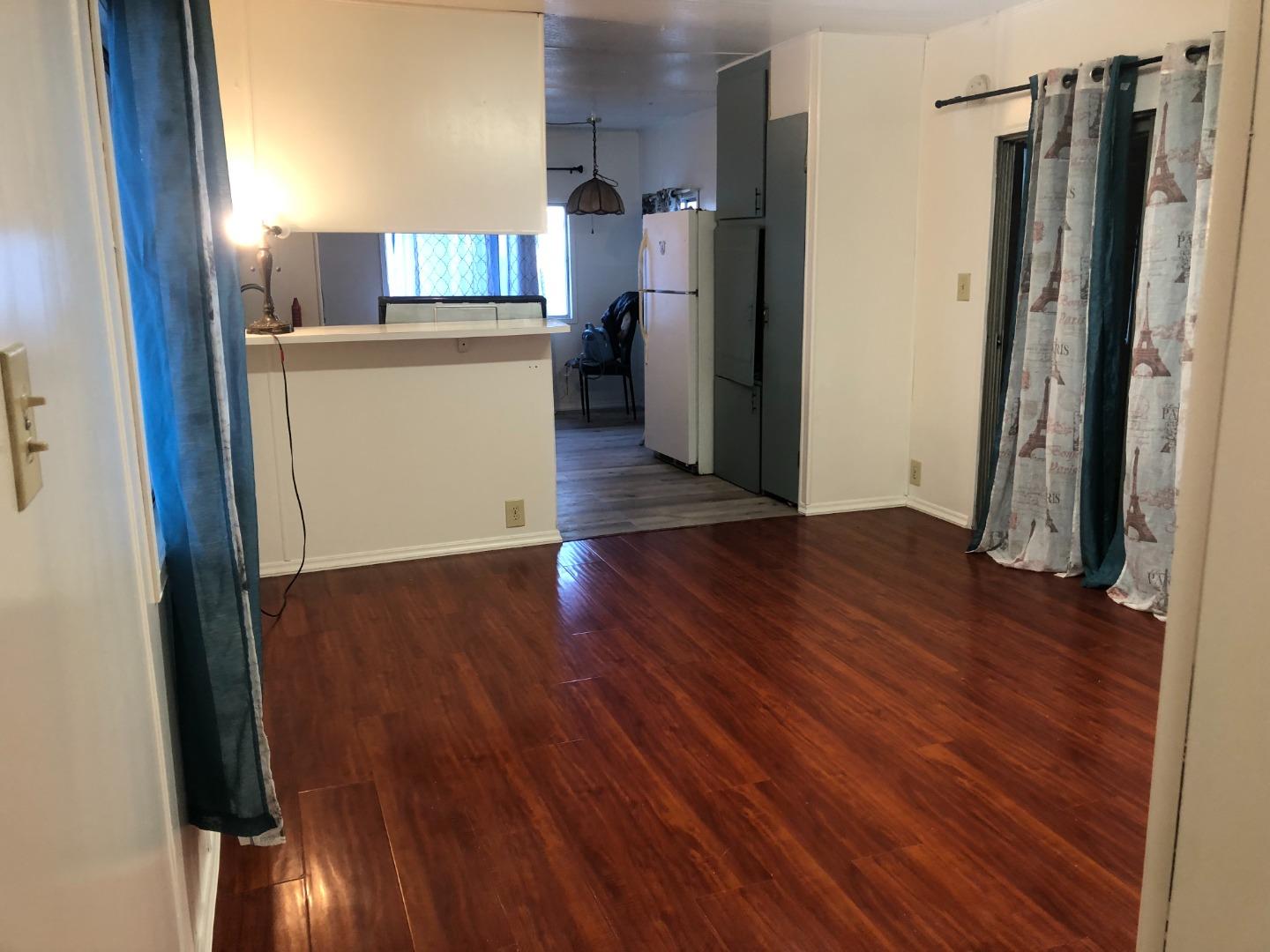 200 Ford Road, Unit 126 San Jose, CA 95138 - Photo 3 of 8 a kitchen with a refrigerator and wooden floor