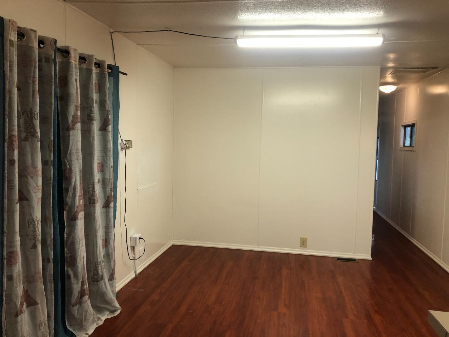 200 Ford Road, Unit 126 San Jose, CA 95138 - Photo 4 of 8 a view of a room with wooden floor and wooden walls
