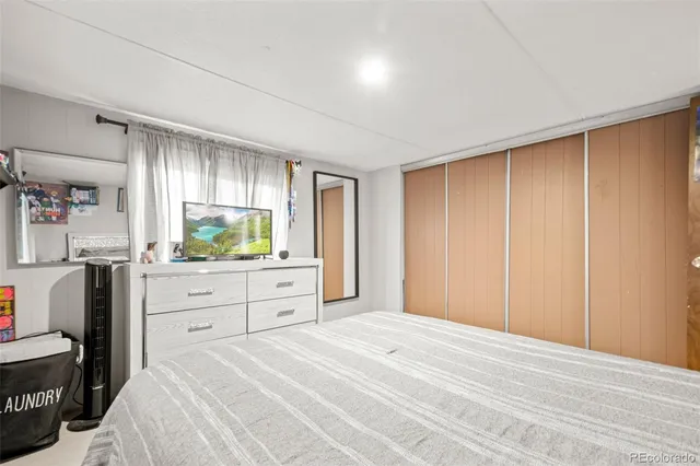 a bedroom with a bed and a dresser