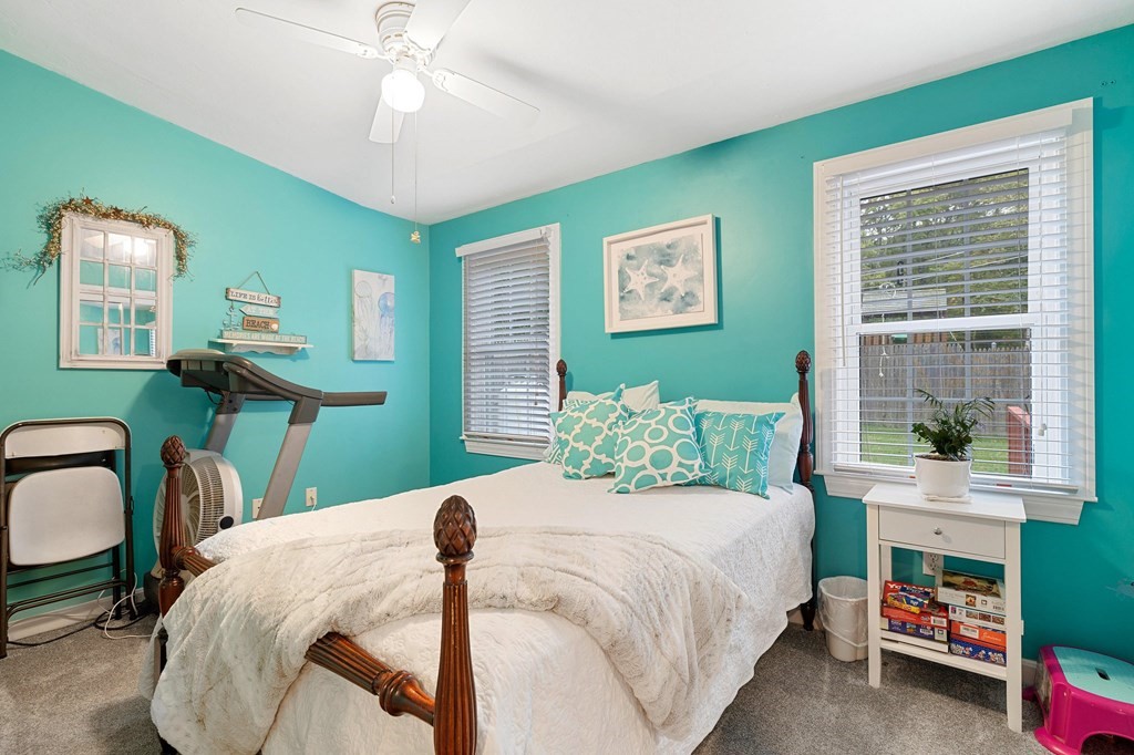 31 Reid Road Douglas, MA 01516 - Photo 16 of 31 a bedroom with a bed and a chandelier