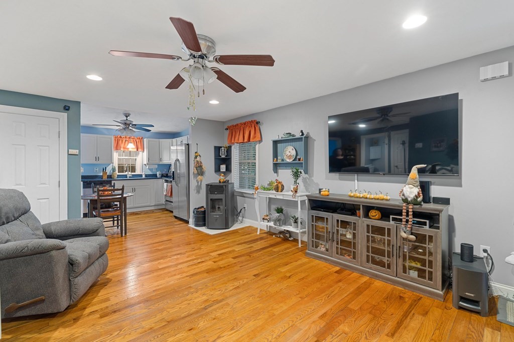 31 Reid Road Douglas, MA 01516 - Photo 7 of 31 a living room with furniture a flat screen tv and kitchen view