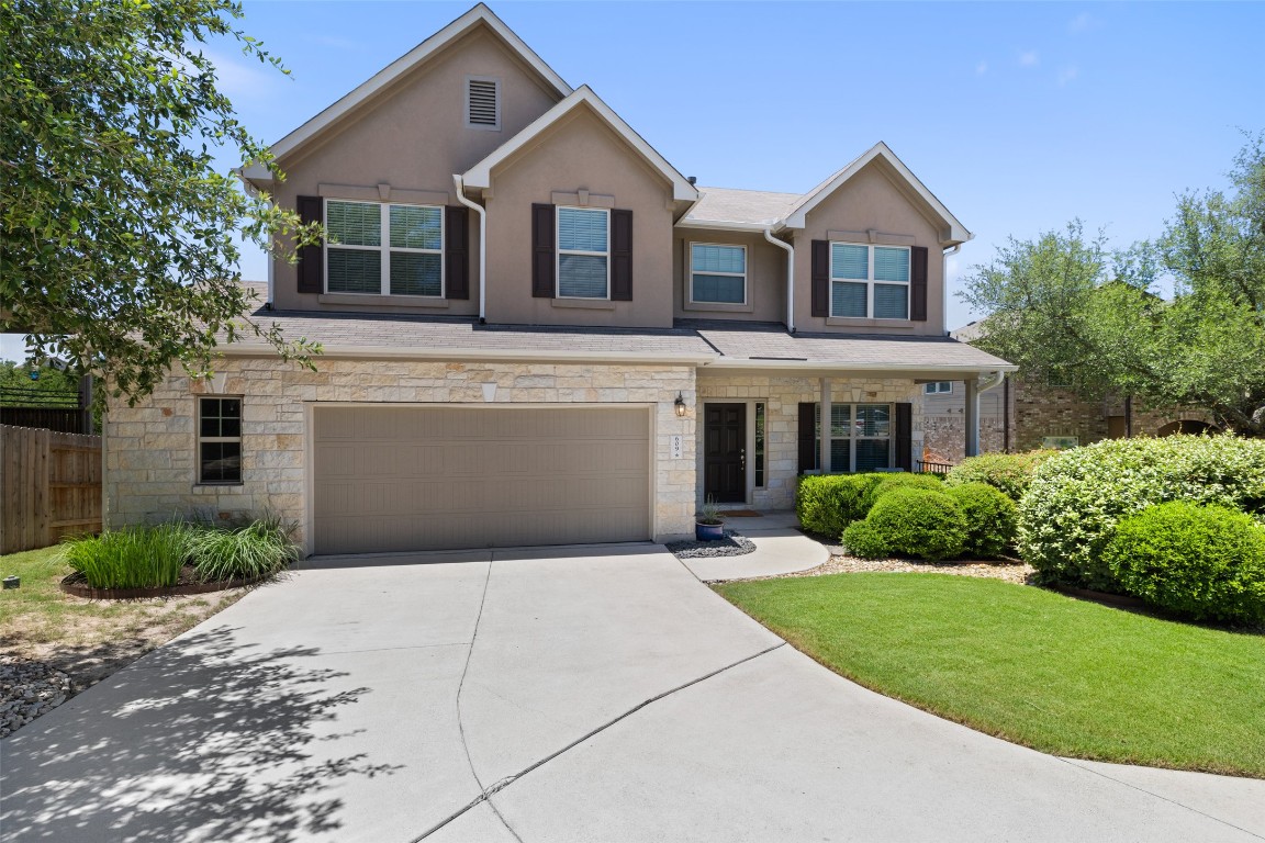 a front view of a house with a yard and garage
