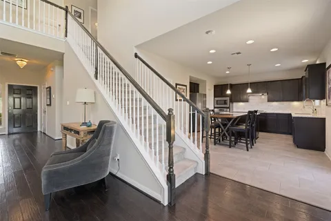 a view of a dining room with furniture wooden floor and a chandelier