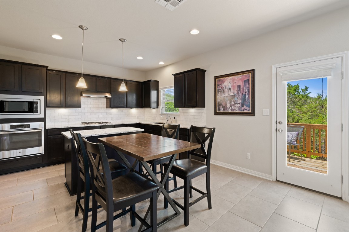 609 Stone View Trail Austin, TX 78737 - Photo 13 of 36 a kitchen with a table and chairs in it