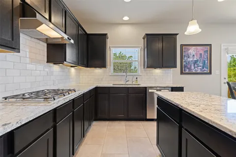 a kitchen with stainless steel appliances granite countertop a sink stove and oven