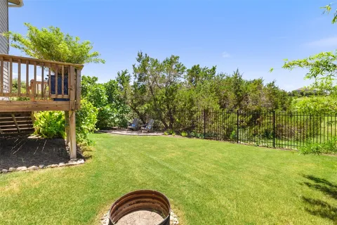 a backyard of a house with lots of green space and fountain