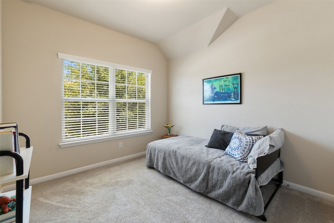 609 Stone View Trail Austin, TX 78737 - Photo 22 of 36 a bedroom with a bed and a window