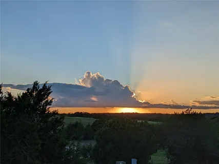 a sunset view with a lake