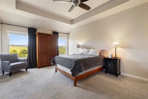 a spacious bedroom with a bed and a couch