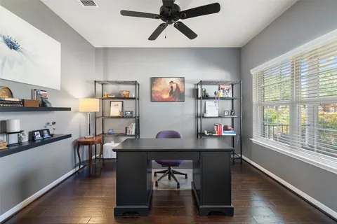 a workspace with furniture window and wooden floor