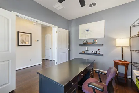a view of a workspace with furniture and wooden floor