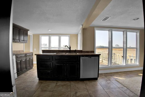a kitchen with a sink and a refrigerator